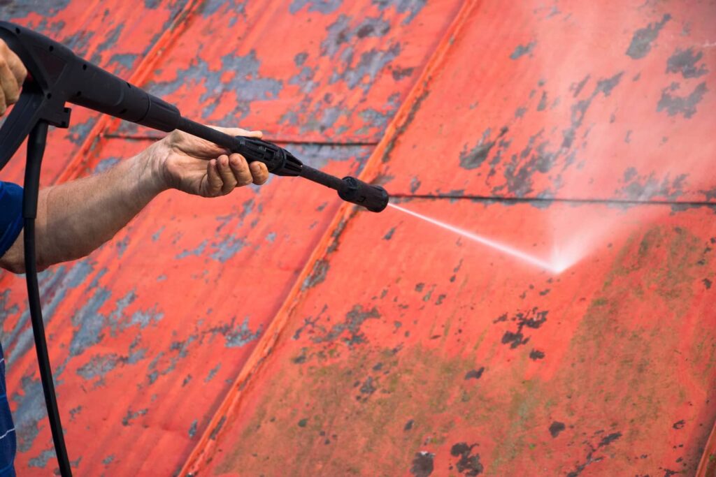 Cleaning a metal roof is part of maintenance.