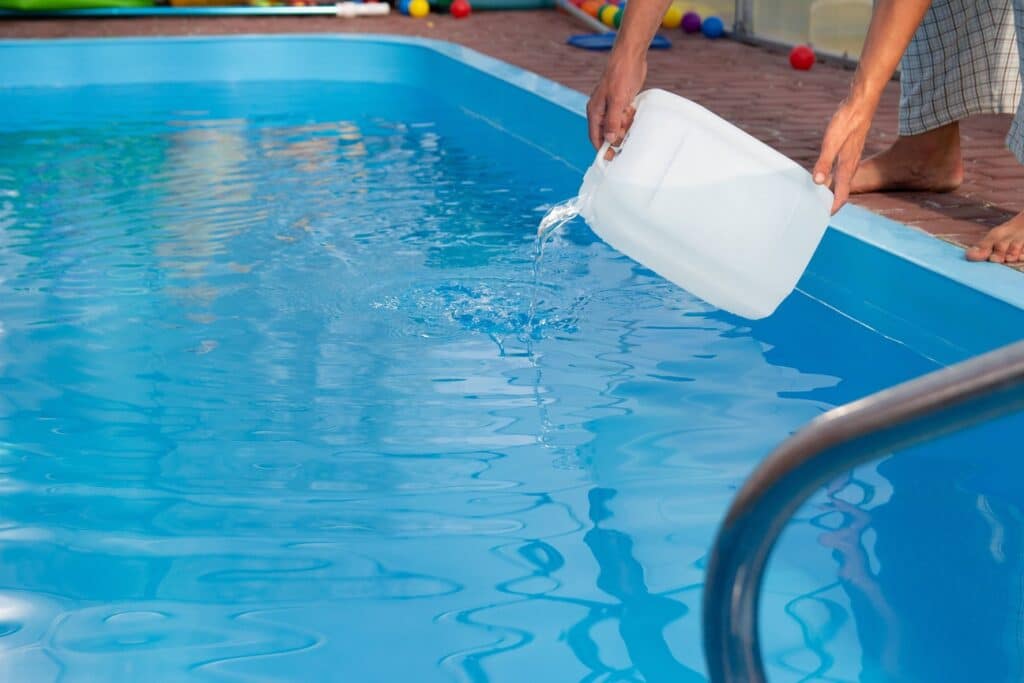 Pouring chemicals into the pool can lower the alkalinity. 