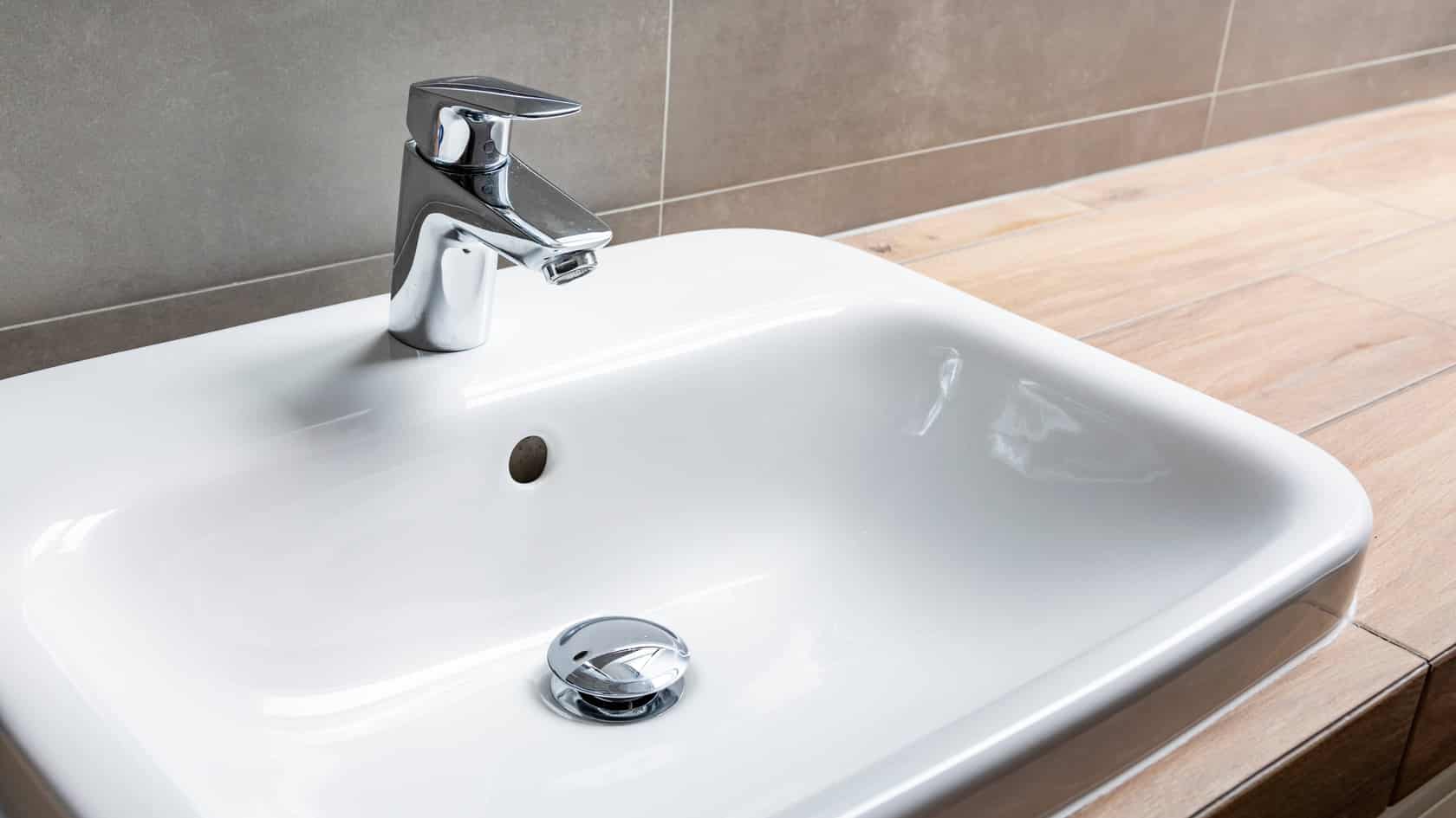 Drain stopper in bathroom sink can be removed if the drain is clogged or needs cleaning.