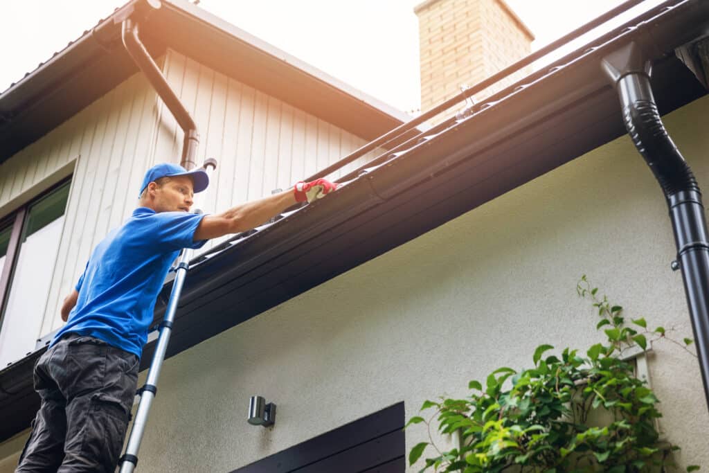 Man Cleaning Gutters